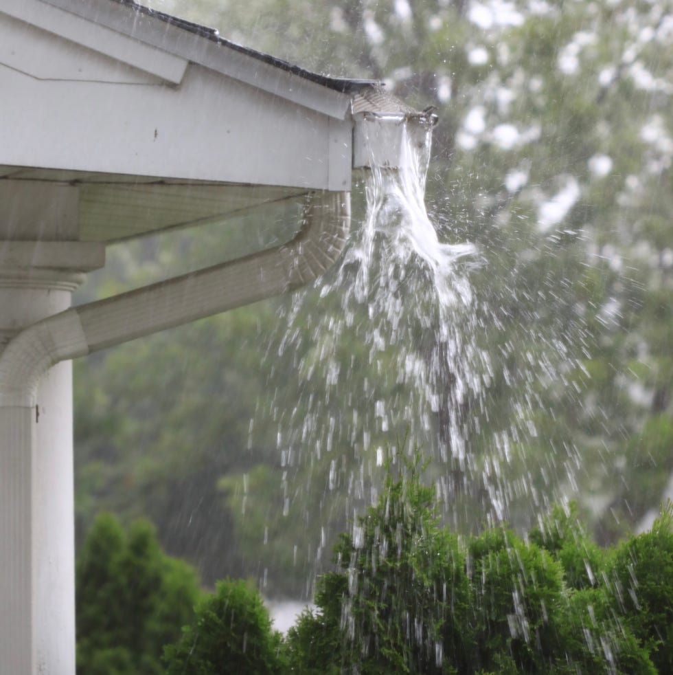 overflowing gutter during heavy rainfall