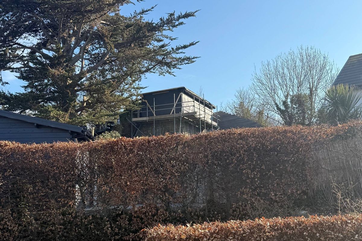 Neighbours of 89 Tan y Bryn Road, Rhos on Sea, say a 'prison-camp watchtower' built without planning consent is overlooking their properties and making life a misery.