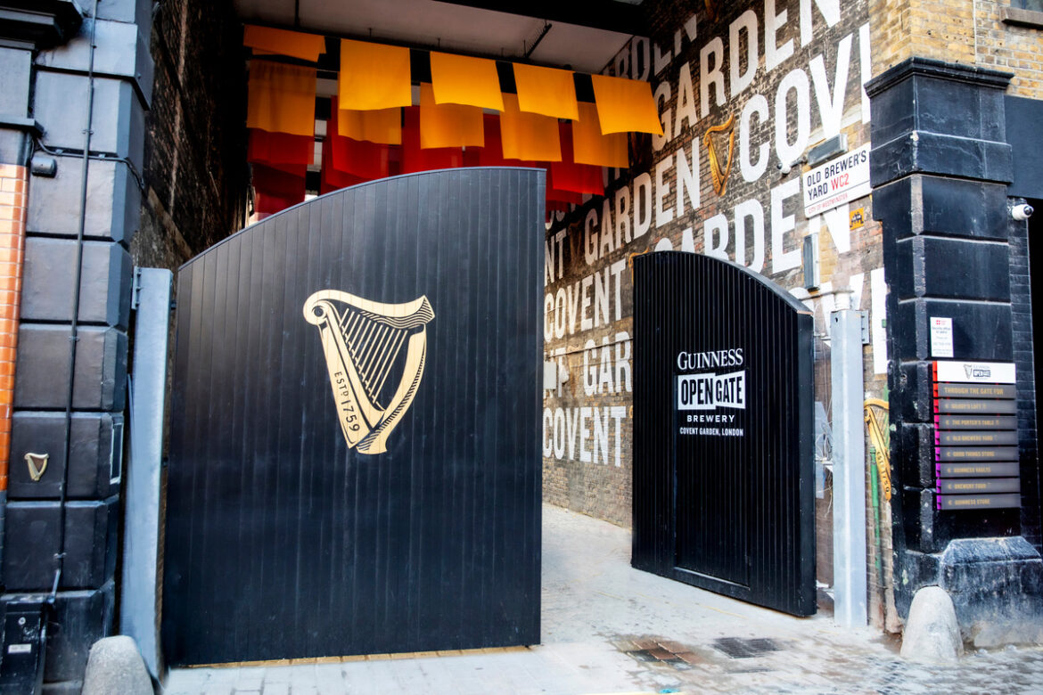 Covent Garden welcomes Guinness brewery Open gate on December 1st at event, showcasing festive decorations and welcoming crowd at business venue.