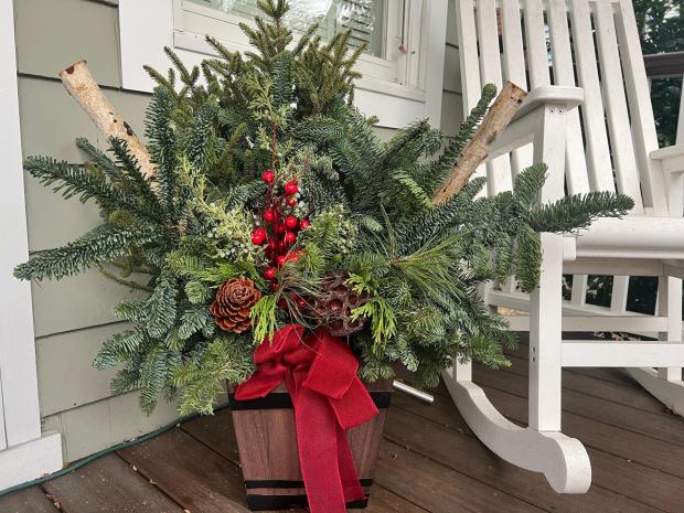 A holiday arrangement of greenery is displayed at a home on Long Island, N.Y., on Dec. 2, 2025. (Jessica Damiano via AP)