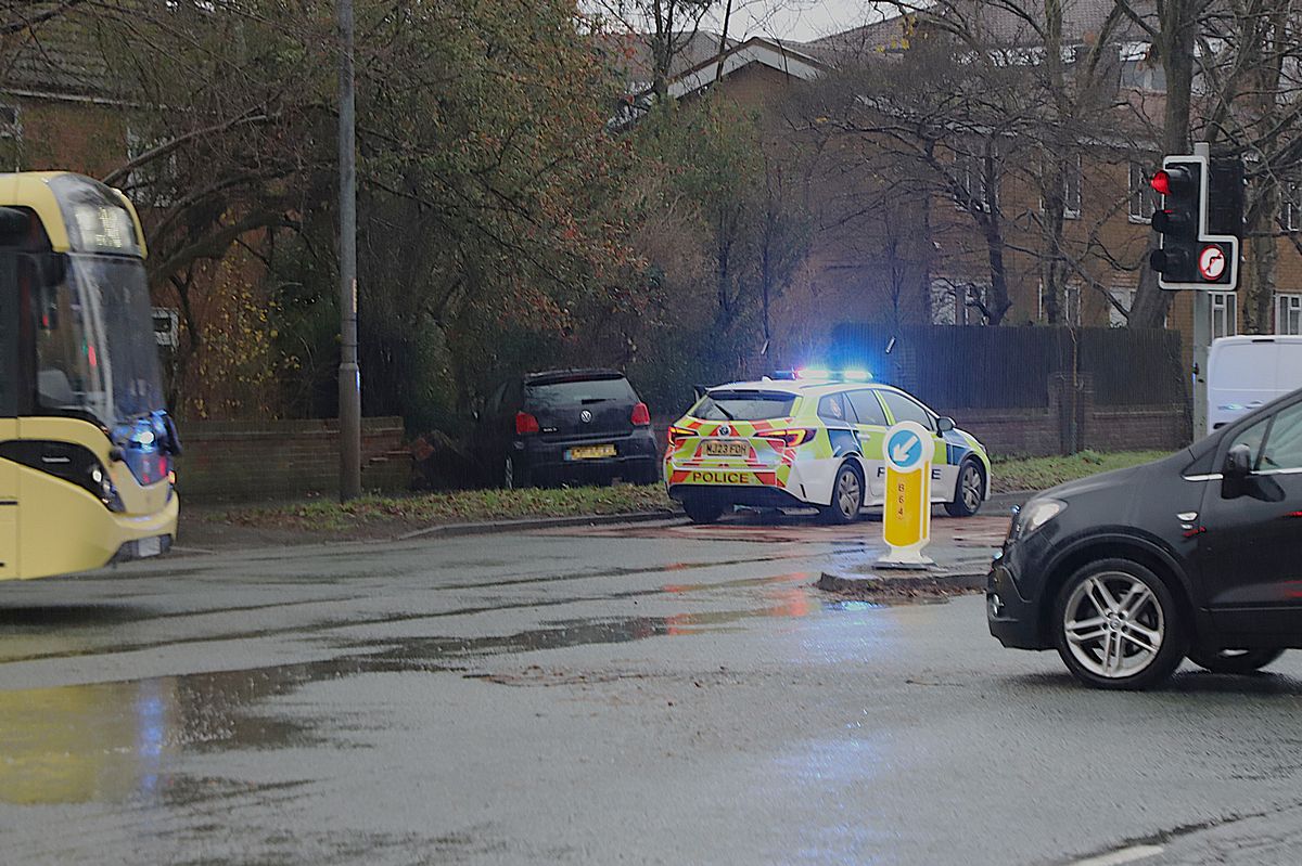 The car veered off the road before hitting the wall behind a row of houses