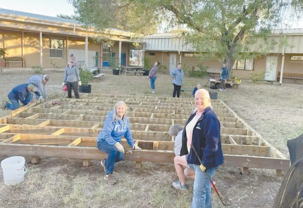 Wilson County Extension Master Gardener Brenda Schaefer (l-r), Intern Vicki Kimball, and Intern Laura Hemblen work alongside other members on their November class project of building raised beds for The Sam Fore Jr. Wilson County Public Library in Floresville. COURTESY/Wilson County Extension Master Gardeners