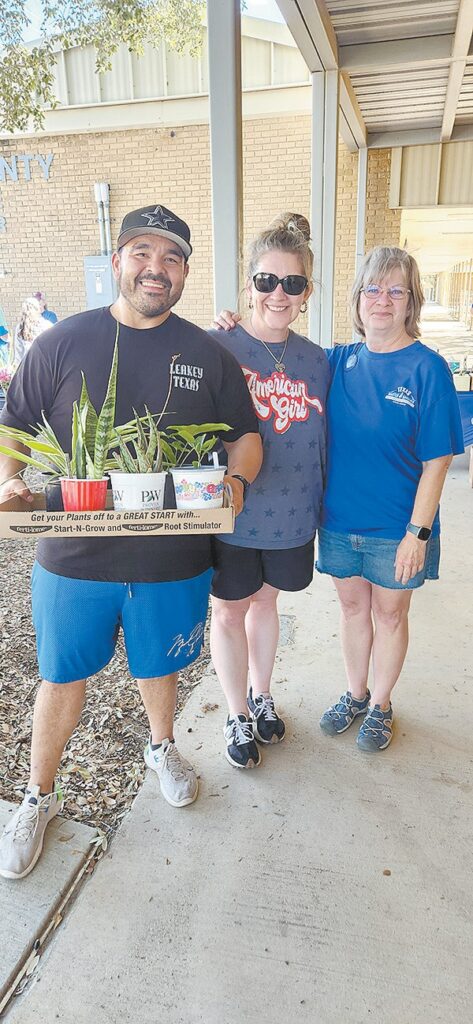 Floresville residents Timothy and Billie Jo Basquez (l-r) visit with family member and Master Gardener Intern Vicki Kimball during the Nov. 15 plant sale and swap. COURTESY/Wilson County Extension Master Gardeners