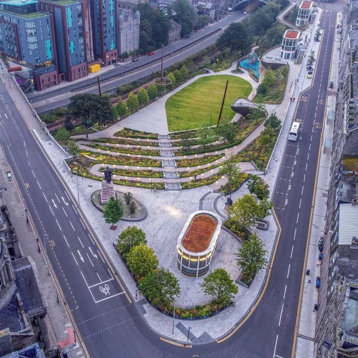 An aerial view of Union Terrace Gardens showing the plant arrangements, a grassy area in the centre, and roads and buildings.