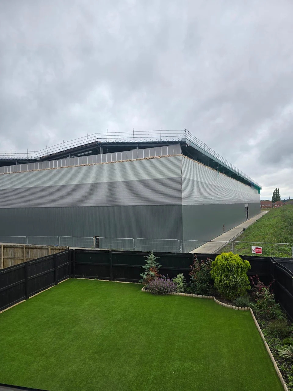 The view of one of the warehouses from a resident's garden (Astley Warehouse Action Group)