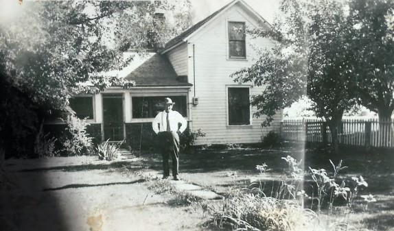 Louis A. Birkley is seen standing in front of a house on what is now known as the Zapf farm property in this photo from 1941. The photo was part of a presentation about the farm given to Boulder County commissioners in 2018. According to Amy Dunbar-Wallis, the rightmost tree is likely an apple tree. (Courtesy of Boulder County Parks and Open Space)