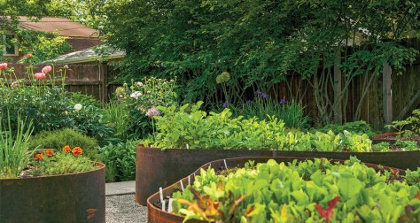 Weathered steel raised beds provide fun and unique play spaces.
