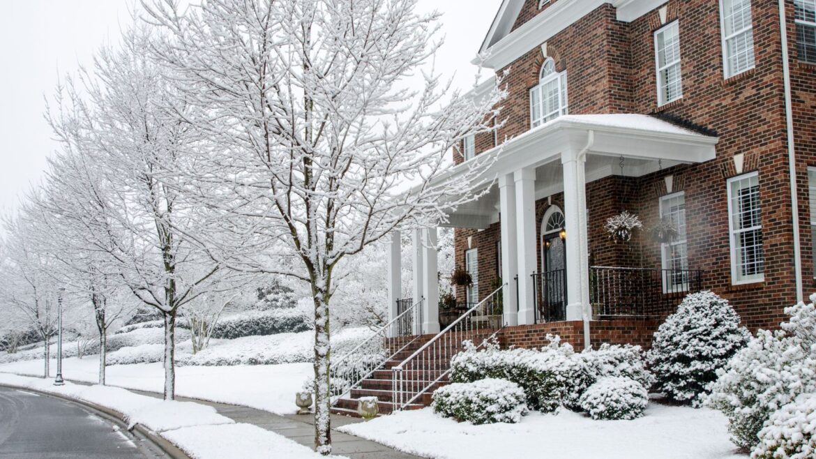 Homeowners Urged to Try This Safe Ice-Melt Alternative A traditional brick American home in snow.