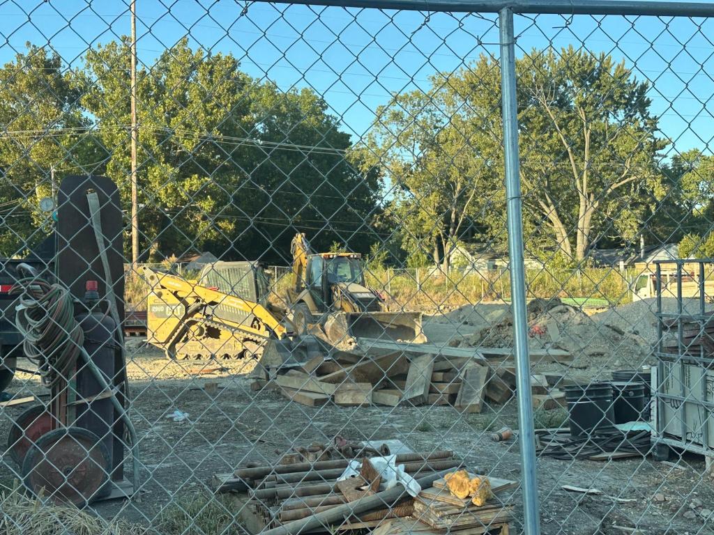 Heavy hauling machinery left in the water detention basin alongside Hedge Road. Photo by Mazie Gierat. 