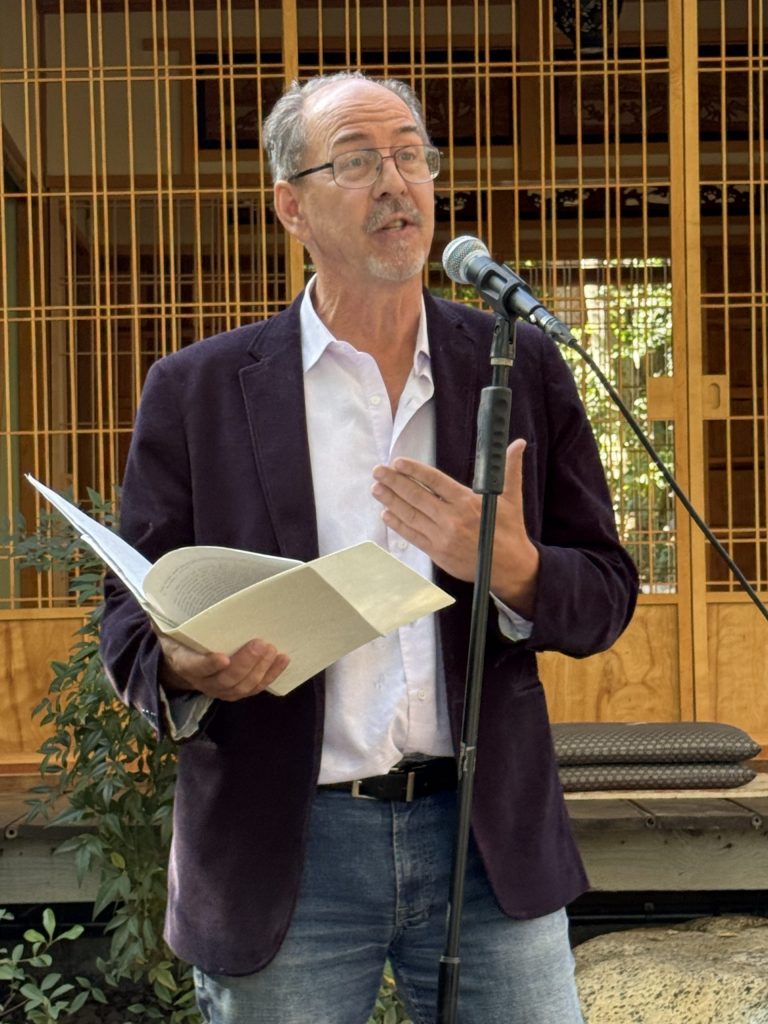 A man wearing a suit and tie talking on a cell phone