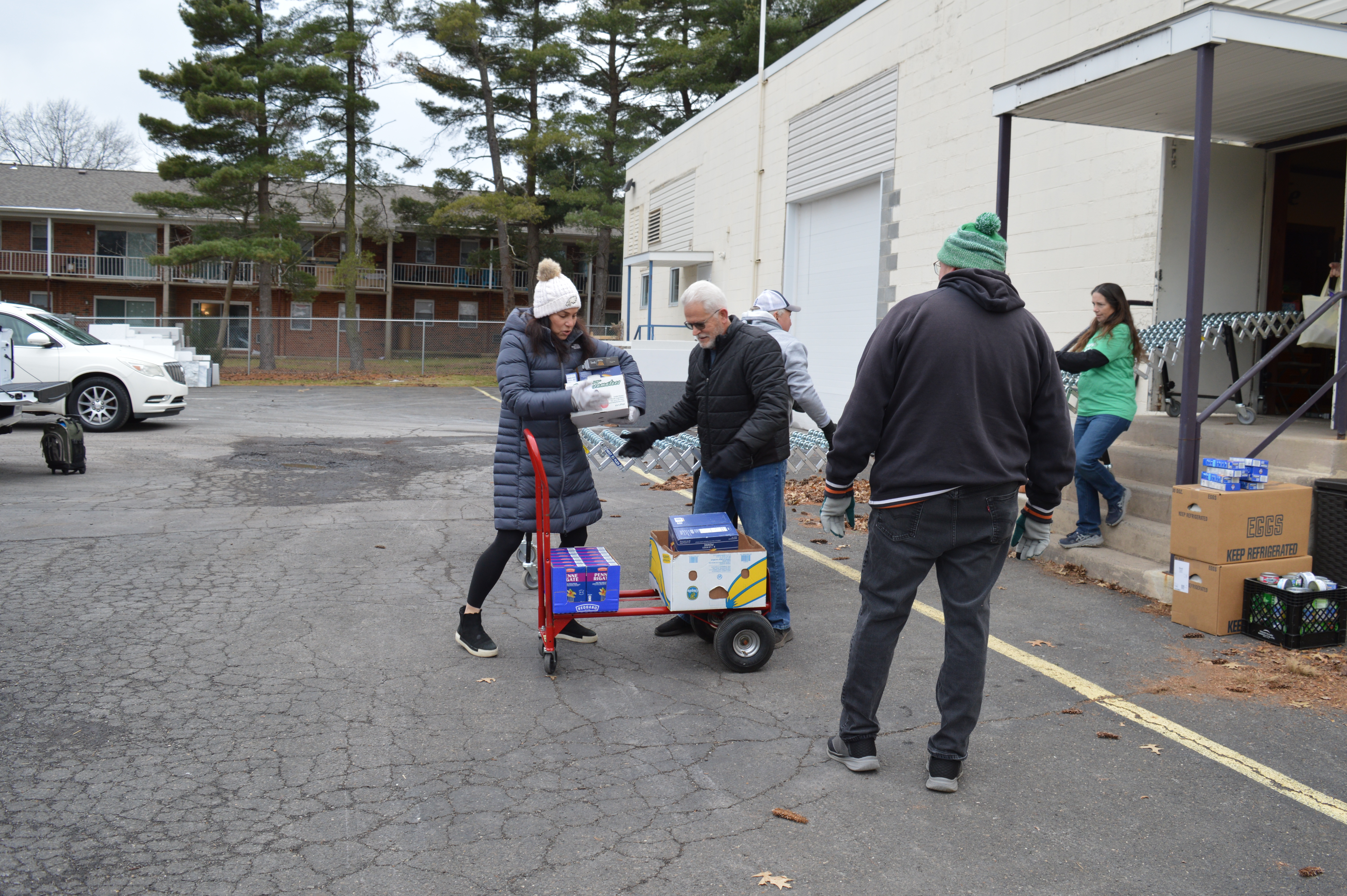 Volunteers pick up food items from the Garden of Health...