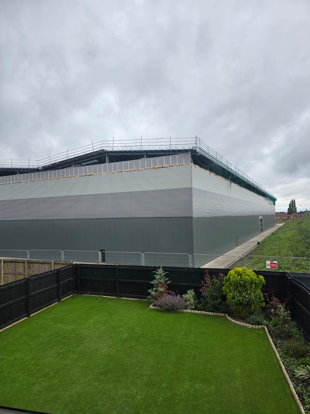 The view of one of the warehouses from a resident's garden