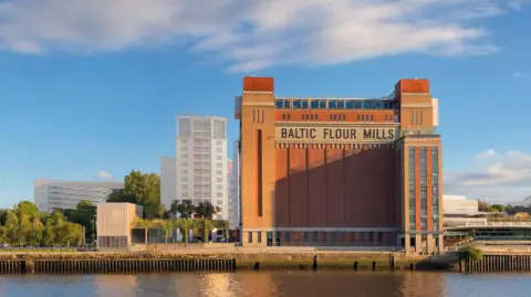 MawsonKerr and Baltic Centre for Contemporary Art A CGI image showing the tall red-bricked Baltic gallery on the banks of the River Tyne. There is lush greenery on the land to the left. Amid the trees and shrubs, there is a large white structure with a walkway connecting it to the gallery.