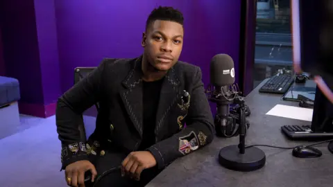James Watkins/BBC John Boyega on the Radio 1 Breakfast show 
