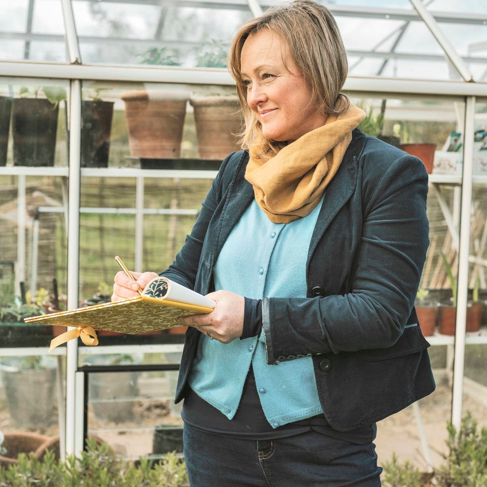 sally standing outside her greenhouse