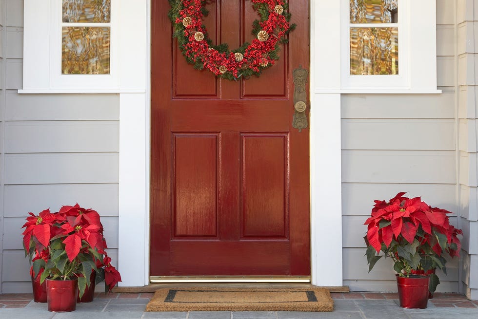 Front door with wreath and poinsettias decoration front door with wreath and poinsettias decoration
