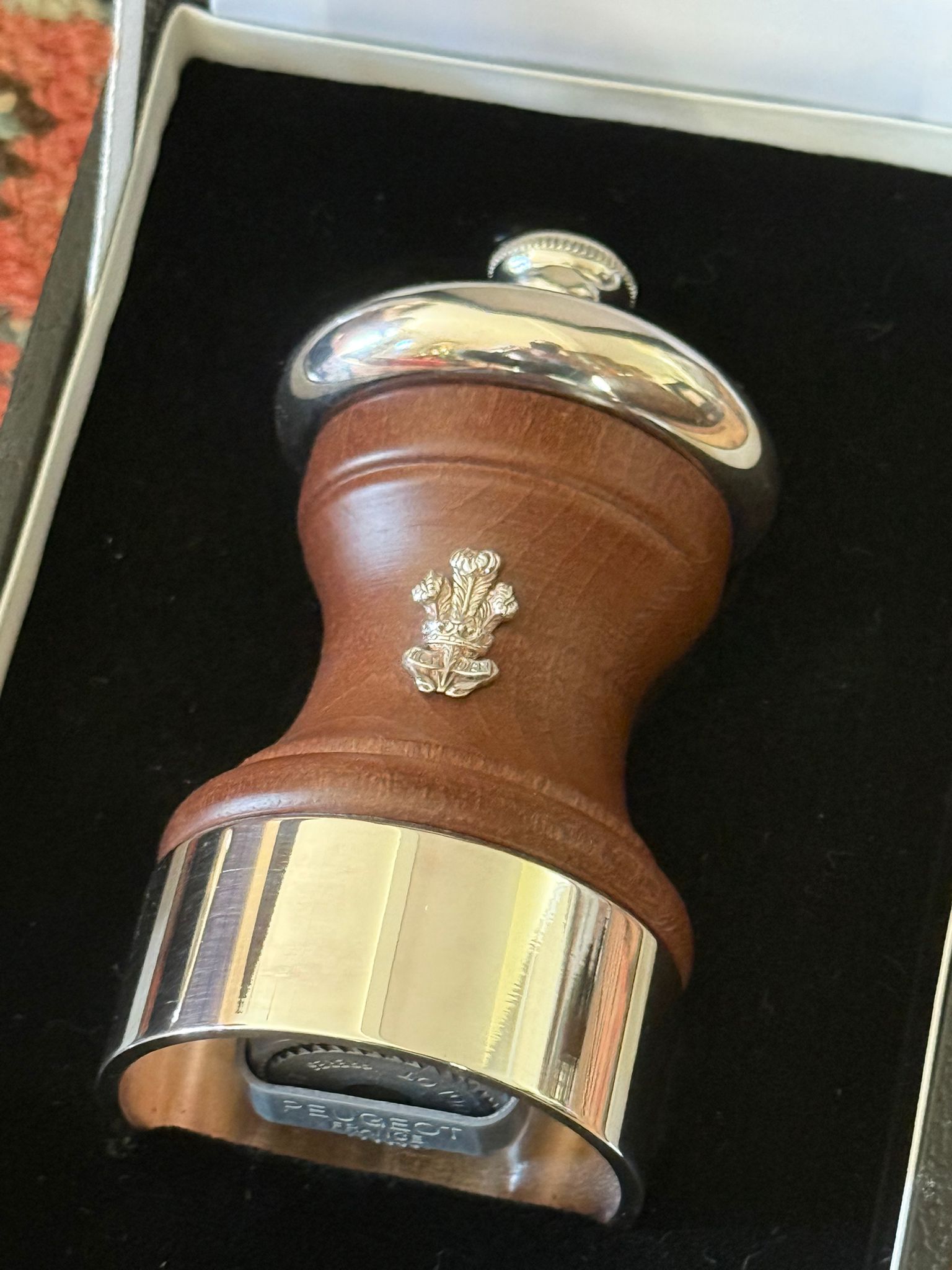 A wooden and silver salt shaker with a Prince of Wales feather
