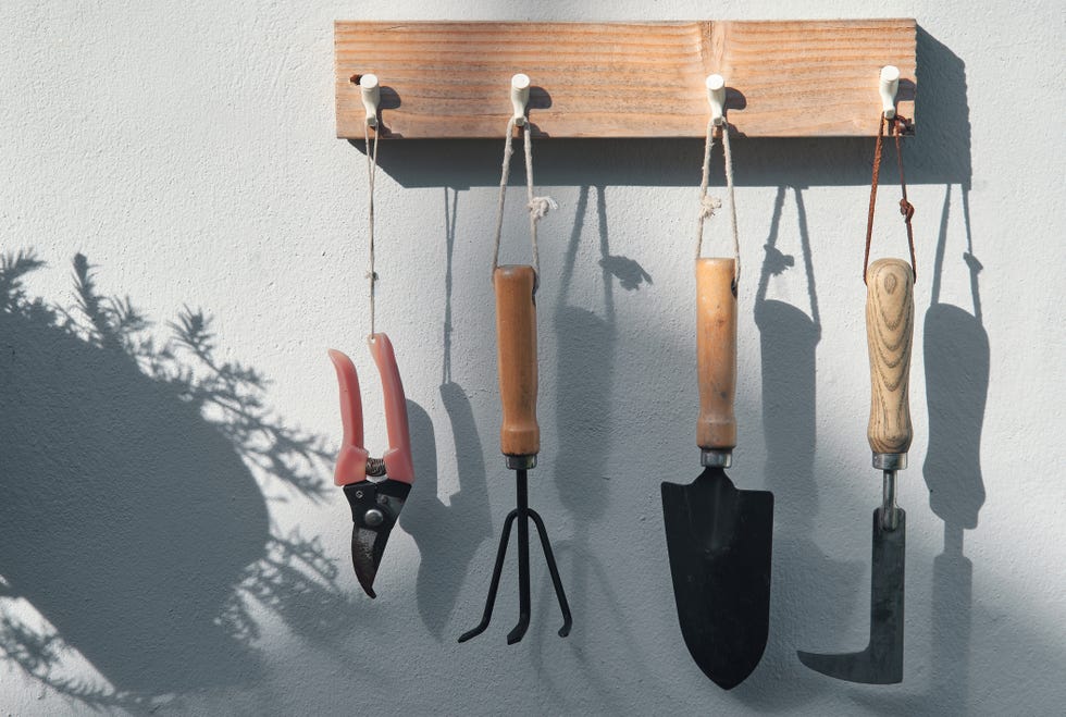 the gardening tools hanging on the wooden dock