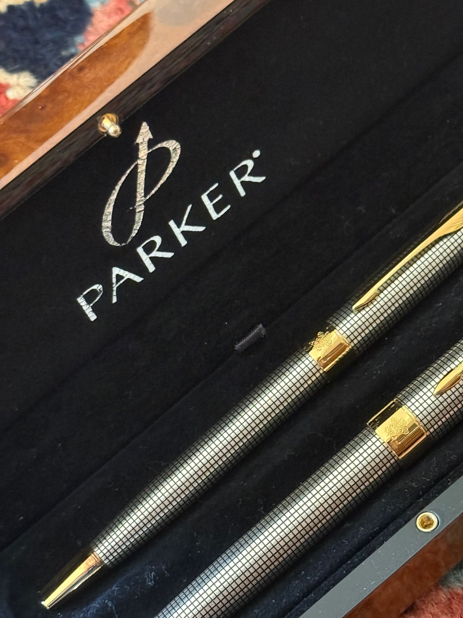 A box of silver and gold Parker pens