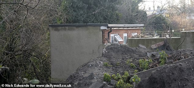 Piles of dirt can be seen on the edge of the newly raised garden
