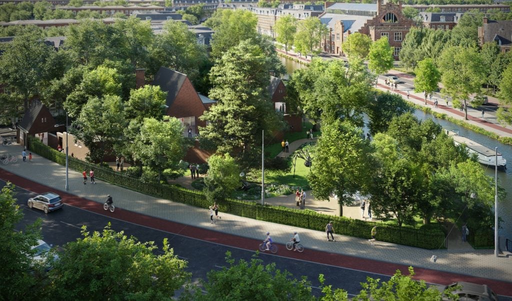 a leafy urban park seen from above with figures moving on a road past area of grass and trees that partly obscure a building