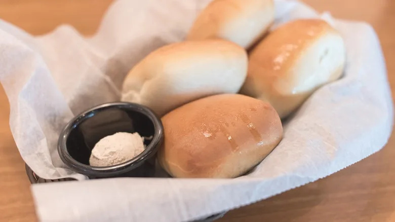 texas roadhouse rolls in basket with honey butter