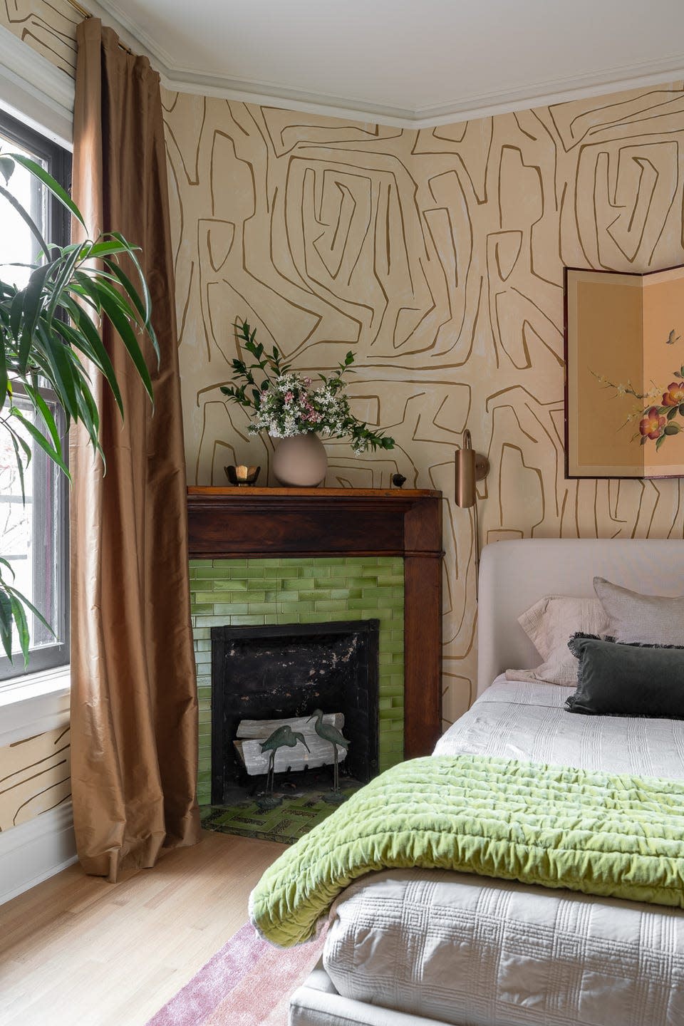 cozy bedroom with unique wall design and a green fireplace