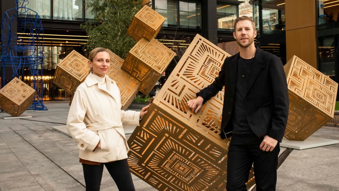 Serge Beaulieu and Yelena Filipchuk posing with one of their installations.