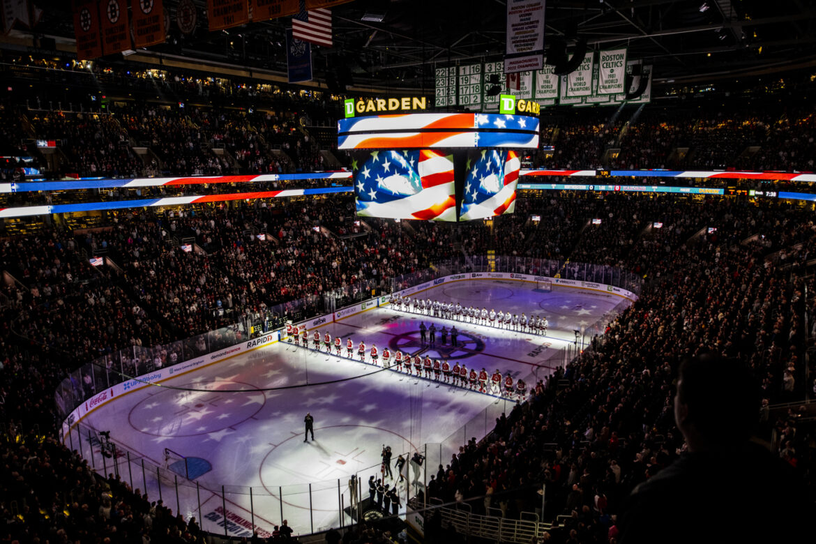 Huskies to Collide with Terriers at TD Garden Inside of TD Garden with the lights down and the players lined up on the rink before the game.