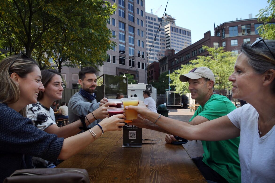 From left: Sarah Richardson; her sister, Julia DePillo; and her husband, Justin Richardson, had a beer with the sisters' parents, Stephen and Patricia DePillo, at Trillium Garden on the Greenway in September 2020.
