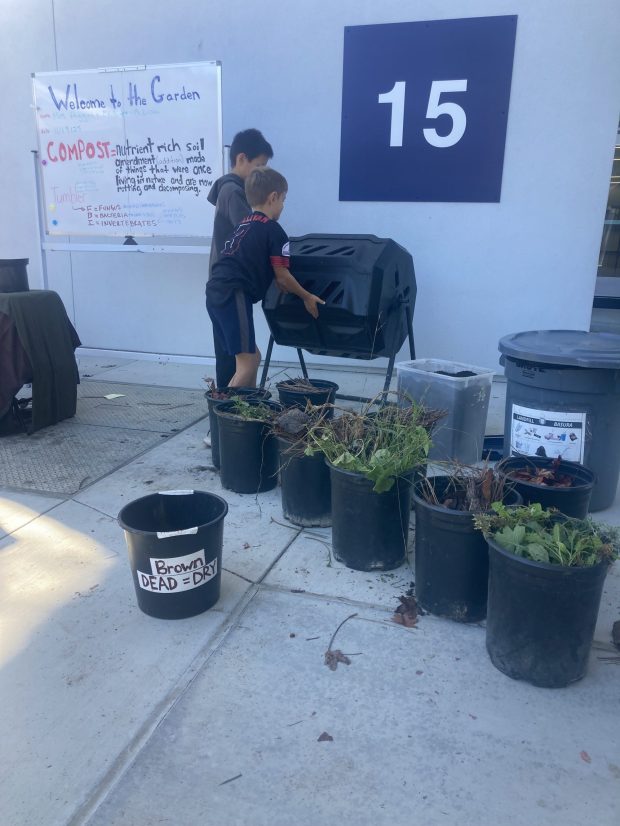La Jolla Elementary School students practice using a composting tumbler as part of the school's gardening program. (Provided by Kira Higgins)