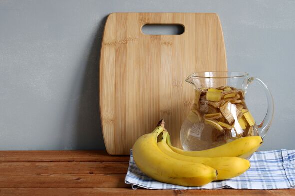 Making banana peel tea: soaking banana peels in water for houseplant fertilizer rich in potassium and phosphorus