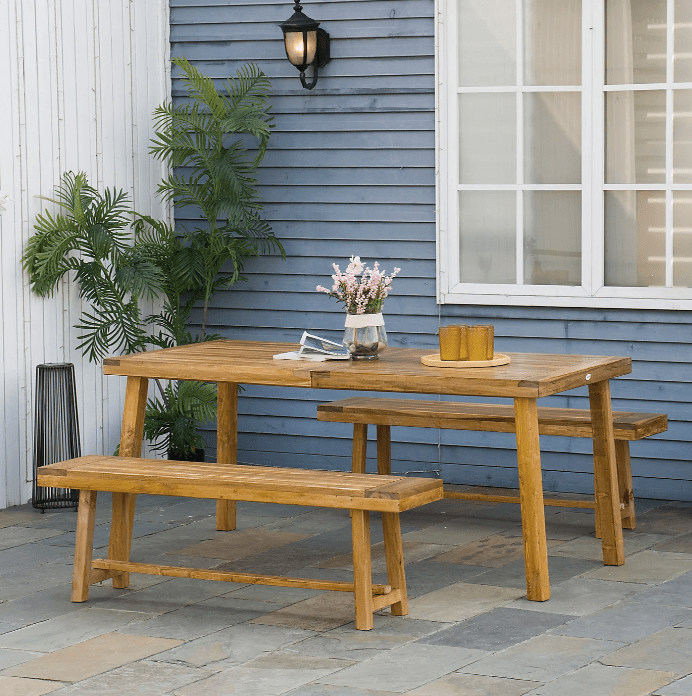 Acacia wood four-seater picnic table and two benches in an outdoor setting.