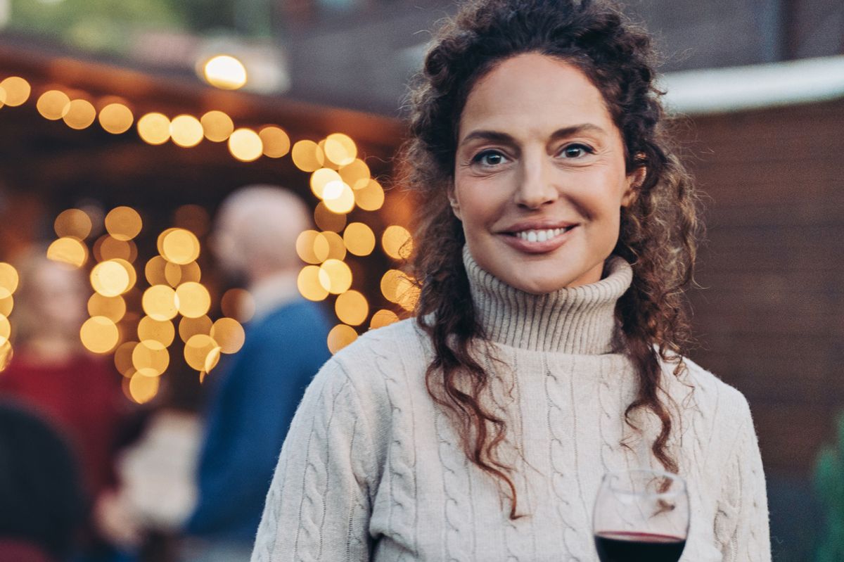 Focus on a happy middle age woman during a garden party