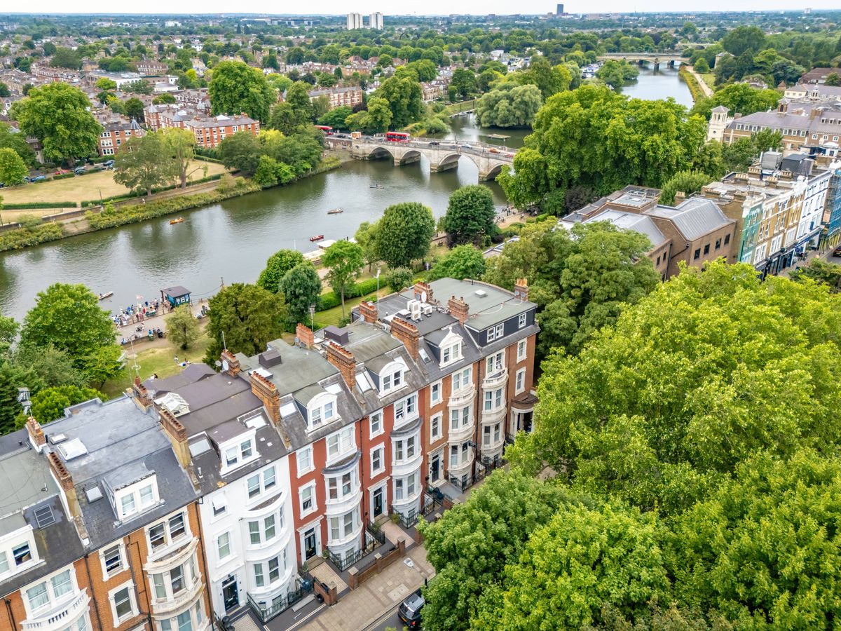 Richmond, London, United Kingdom. 21 June 2025. Aerial view of Houses and River Thames in Richmond, London