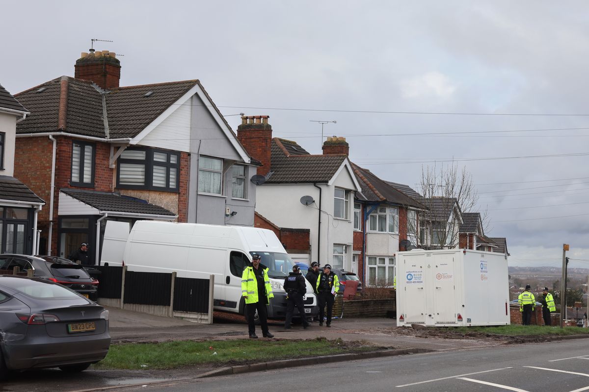 Police officers pictured outside a property in Broad Avenue, Leicester