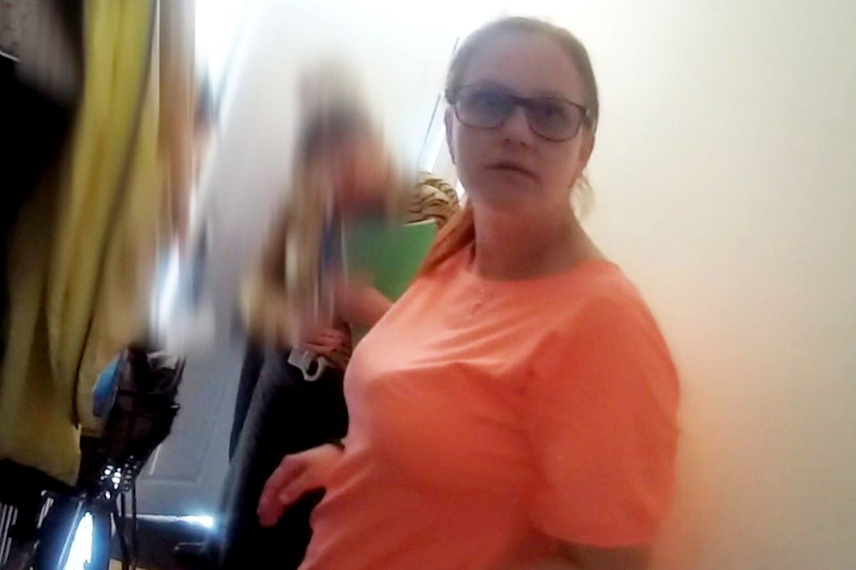 Anna Podedworna being arrested by police