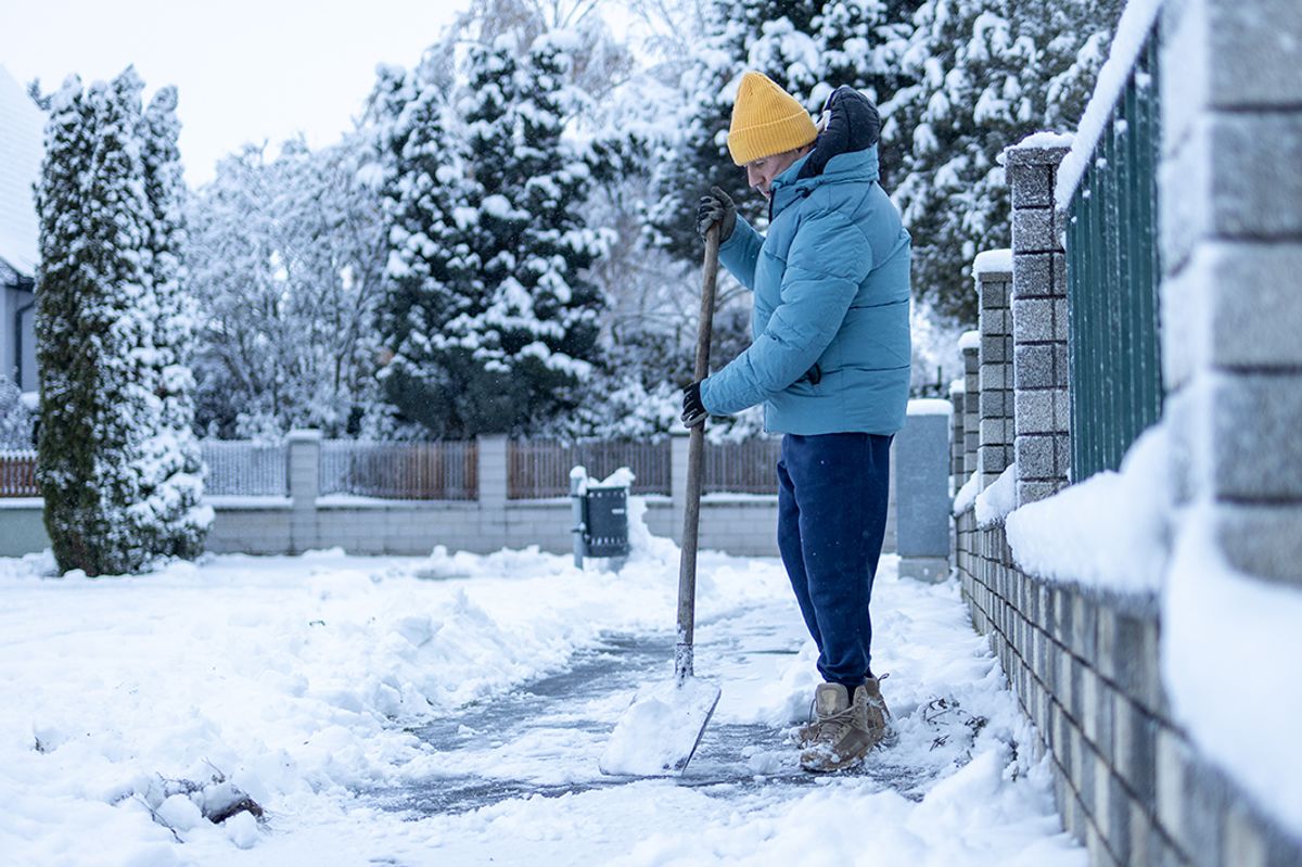 Man clearing snow from pathway. 