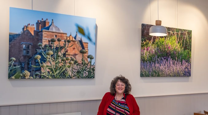 1. Award winning Ripon photographer Helen Tabor pictured alongside large canvas prints of her work in the café at Kiplin Hall and Gardens. Credit Helen Tabor (002)