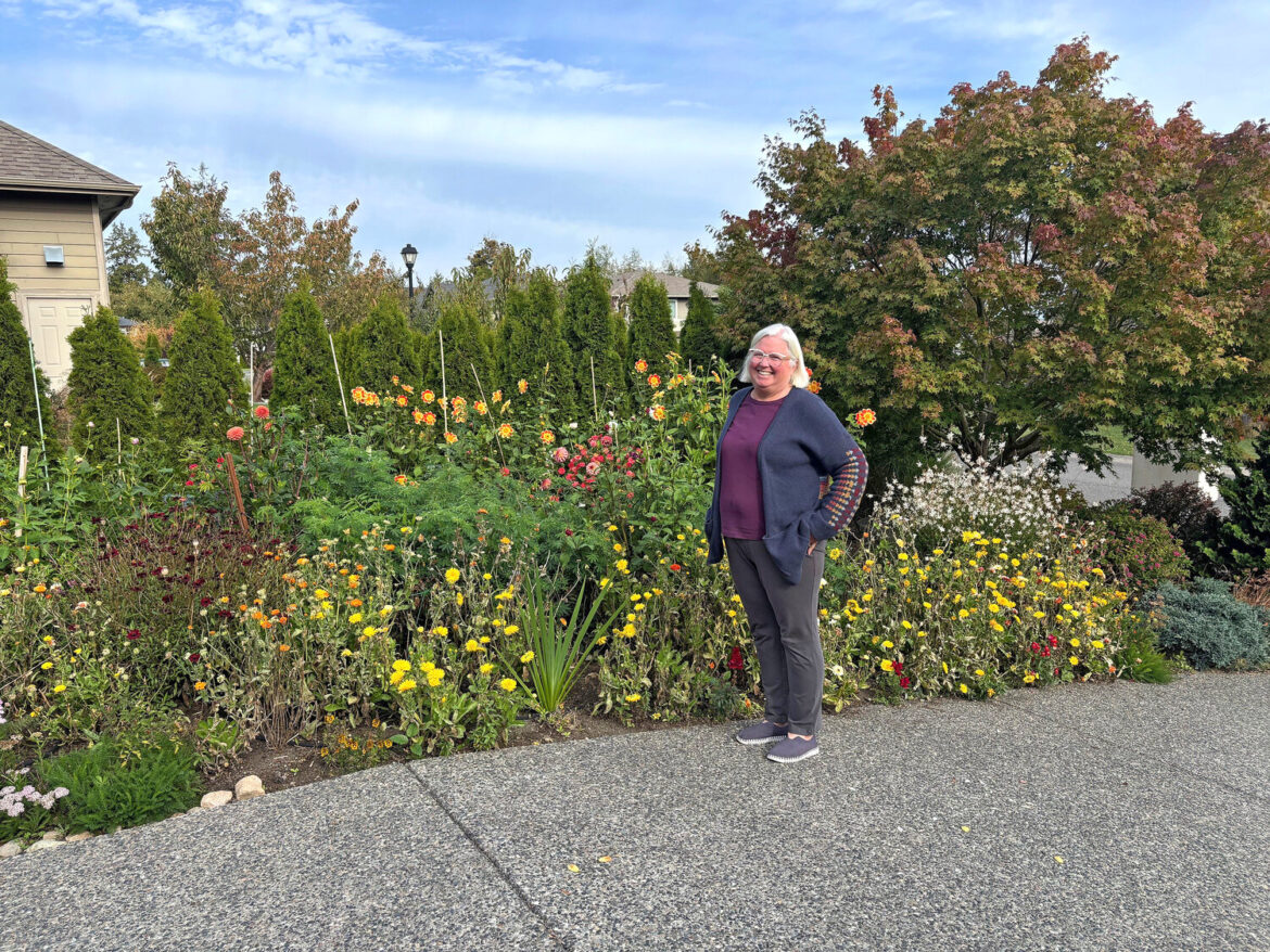 Birch Bay resident Laurie Bender in front of the garden she created using what she learned through WSU Extension&rsquo;s Gardening Green course last year.