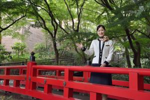 Popular photo spot on a traditional red bridge in Chinzanso Garden