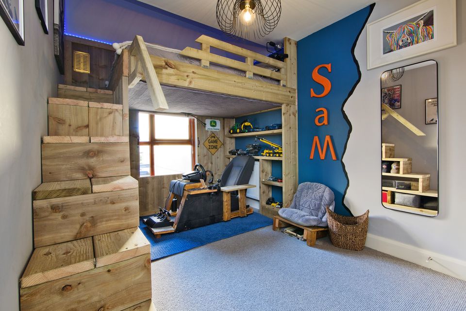 A bedroom with hand-built bed and steps over a gaming area at 14 Castlelyon Avenue, Newcastle, Co Dublin