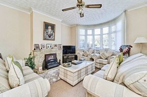 A bright front lounge with a bay window and central fireplace, ideal for everyday living and relaxing