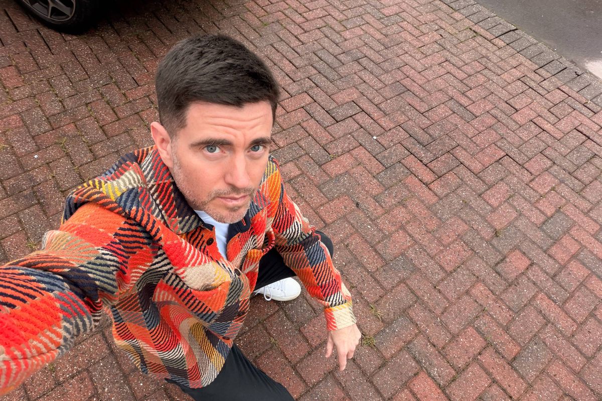 Steffan Rhys takes a selfie while kneeling down on his driveway