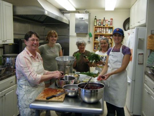 people pose for a photo in a kitchen