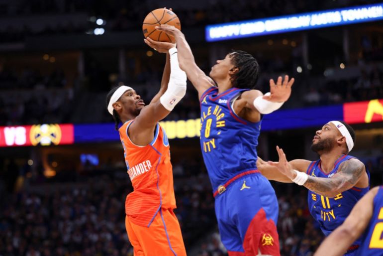 DENVER, COLORADO - FEBRUARY 01: Shai Gilgeous-Alexander #2 of the Oklahoma City Thunder shoots the ball over Peyton Watson #8 of the Denver Nuggets during the fourth quarter at Ball Arena on February 1, 2026 in Denver, Colorado. NOTE TO USER: User expressly acknowledges and agrees that, by downloading and or using this photograph, User is consenting to the terms and conditions of the Getty Images License Agreement. Justin Tafoya/Getty Images/AFP (Photo by Justin Tafoya / GETTY IMAGES NORTH AMERICA / Getty Images via AFP)