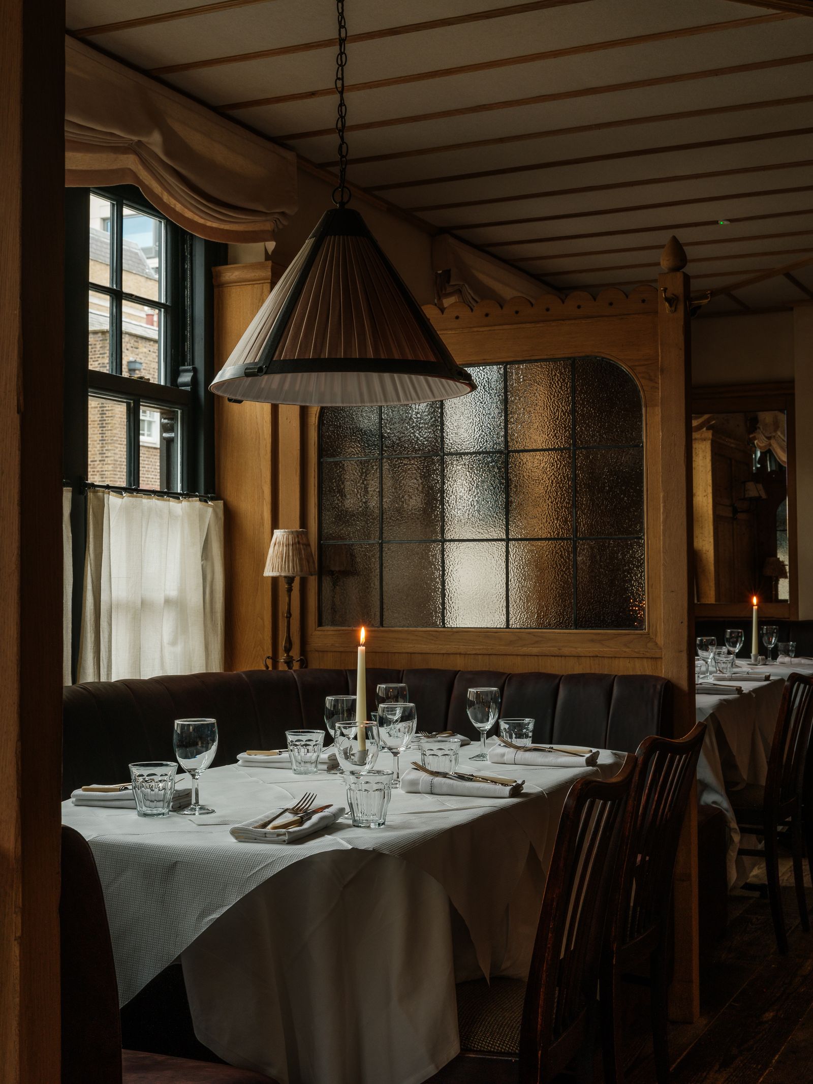 Image may contain Architecture Building Dining Room Dining Table Furniture Indoors Room Table Lamp and Cup