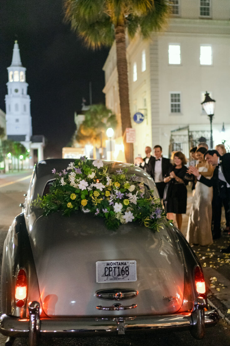 Flowers on a getaway car at a wedding