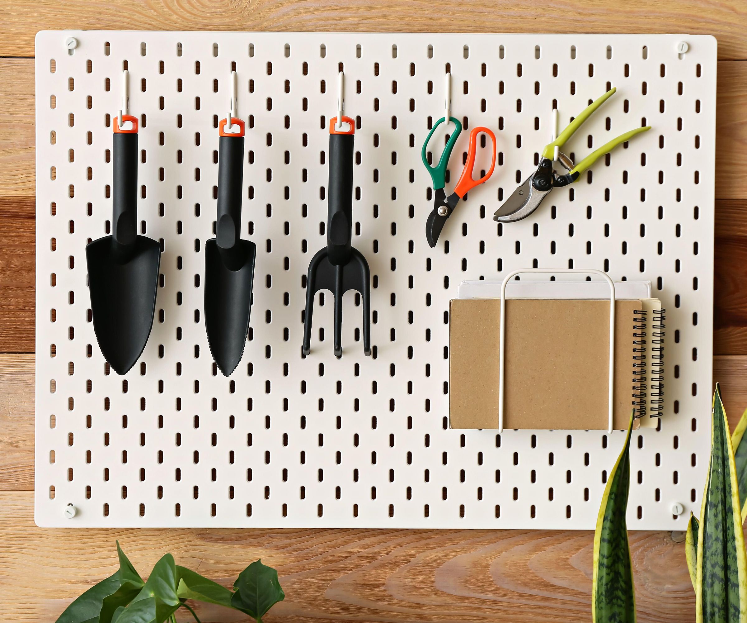 A pegboard organising gardening tools