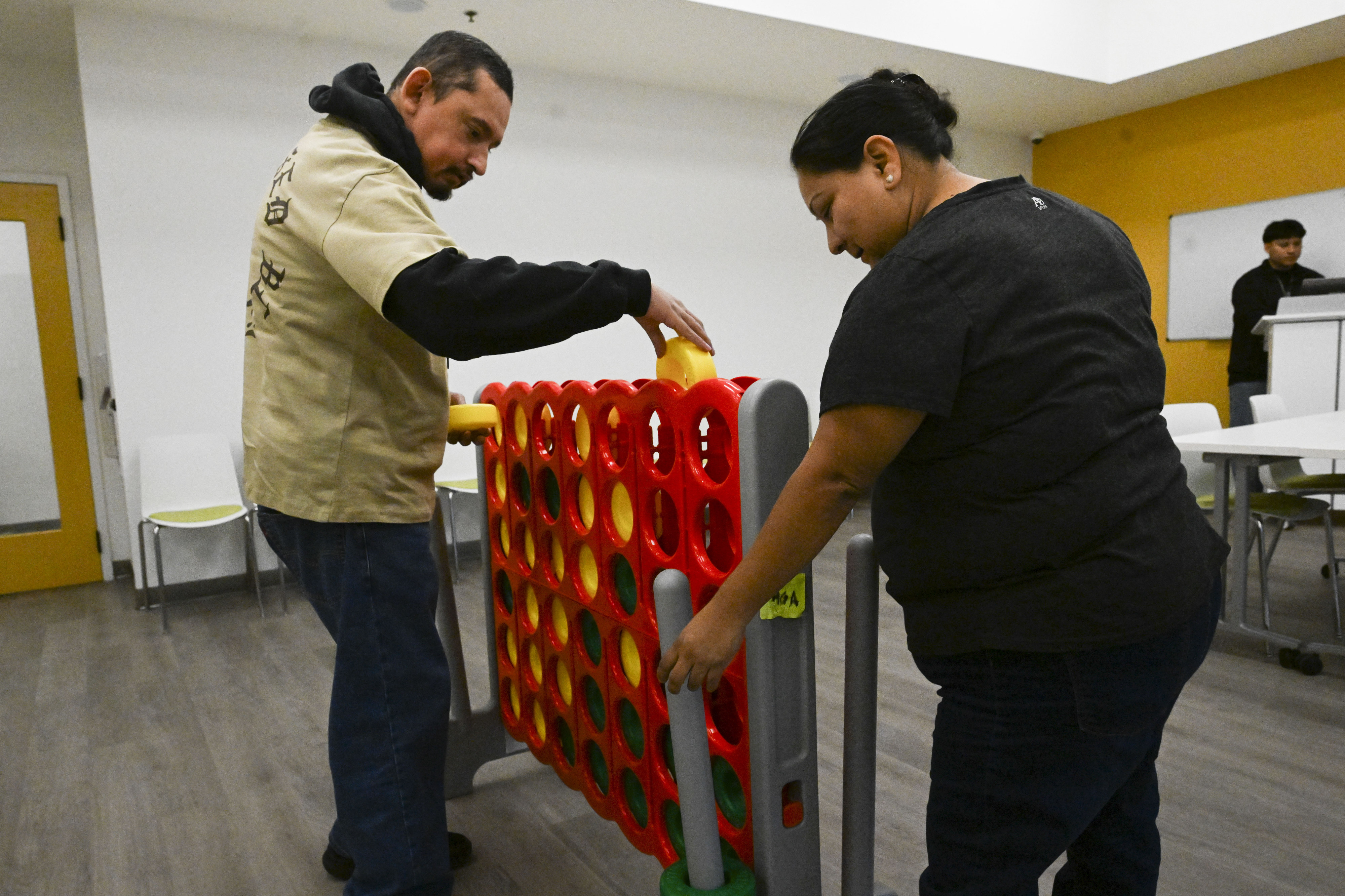 From left, Michael Padilla and Nancy Aguilar play a game...